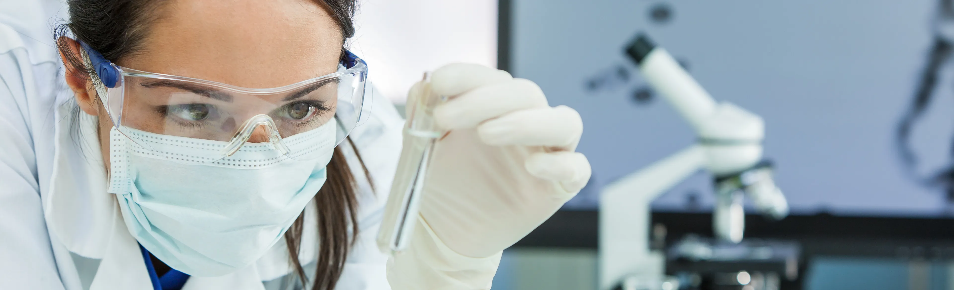 woman in lab wearing PPE