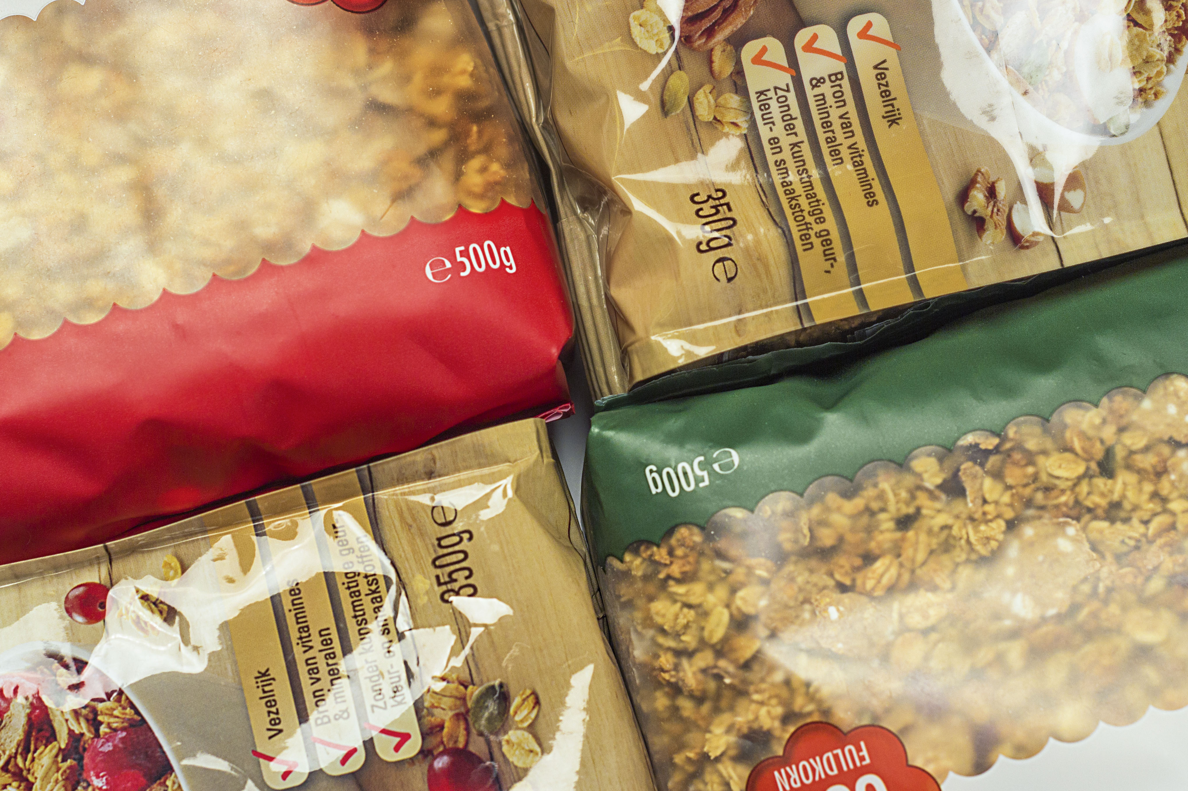 Close-up of packaged food products with e-marking and declared net weight printed on the packaging, showing compliant quantity labelling.
