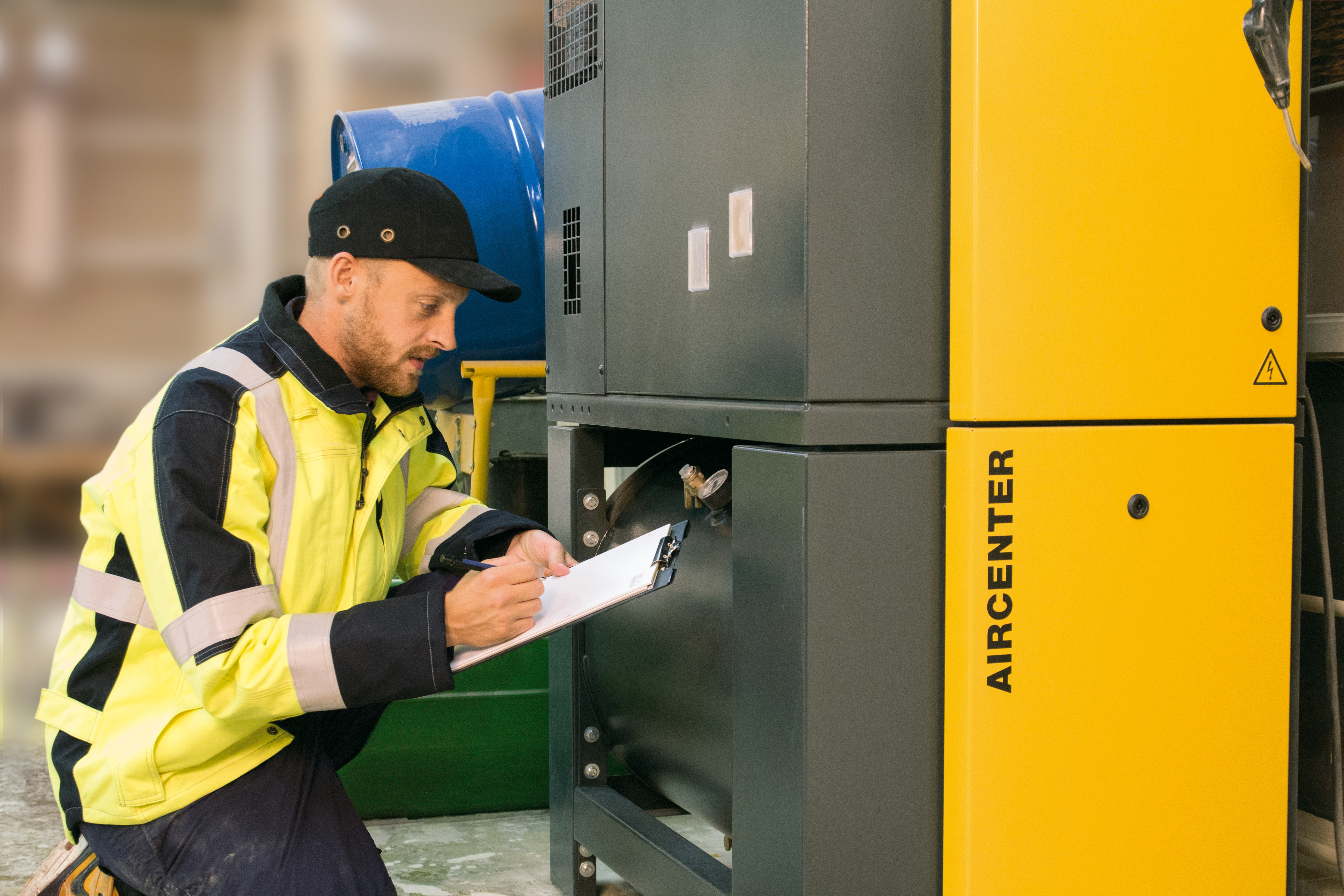 Inspektør registrerer inspektionsdata under vurdering af industrielt trykbærende udstyr i en driftsfacilitet.