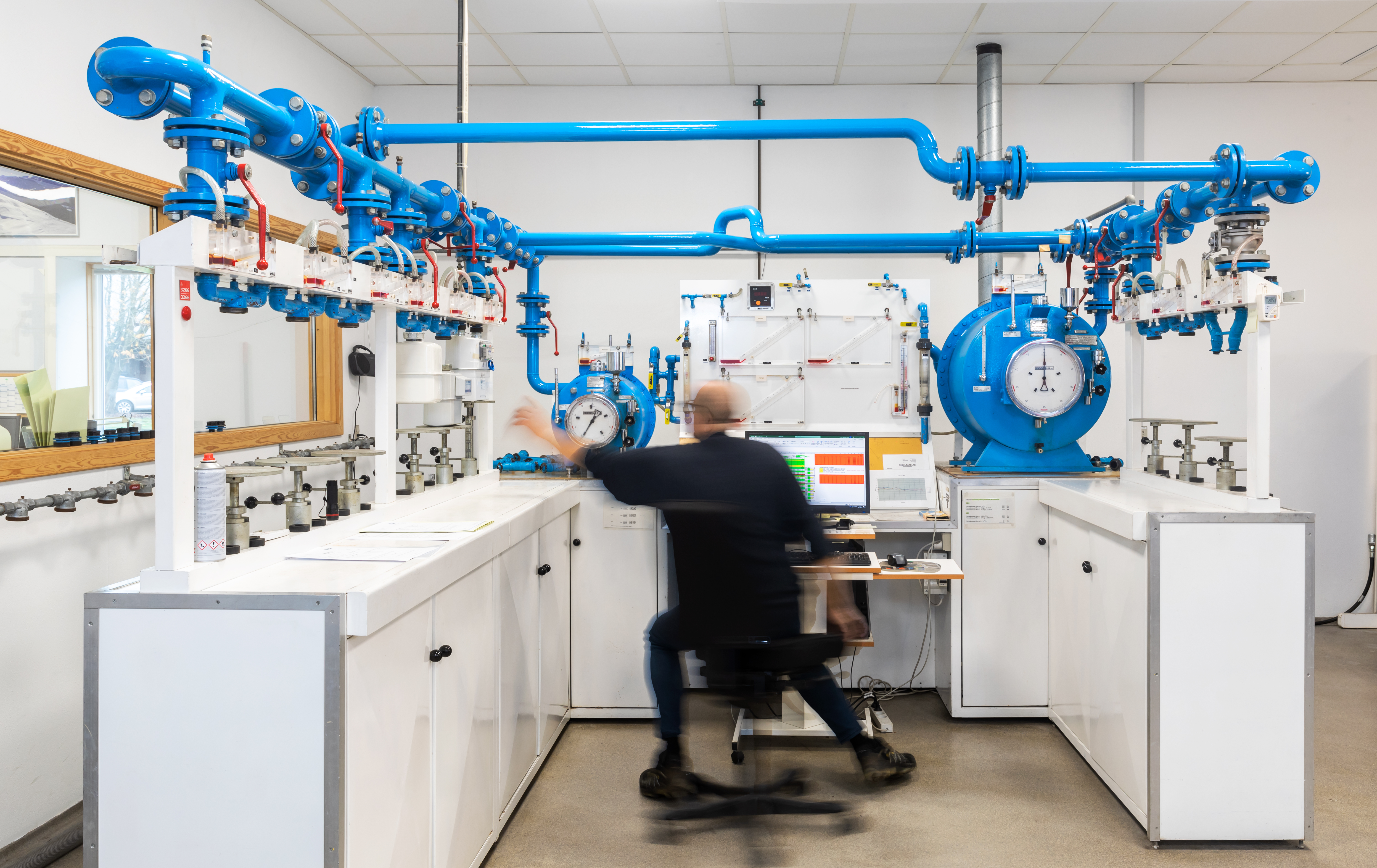 The image shows a test engineer operating the test setup at our air calibration facility for flow meter testing.