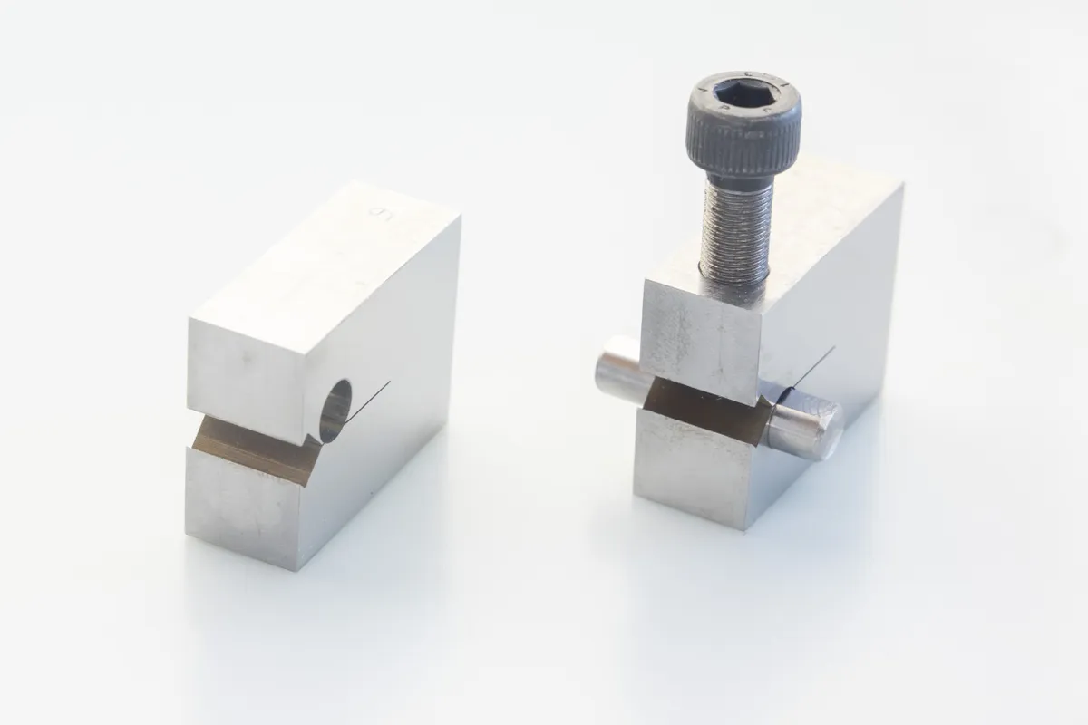 Fracture mechanics metal specimen next to a ruler